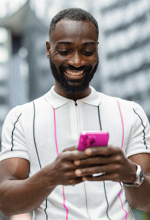 Man holding a pink mobile phone